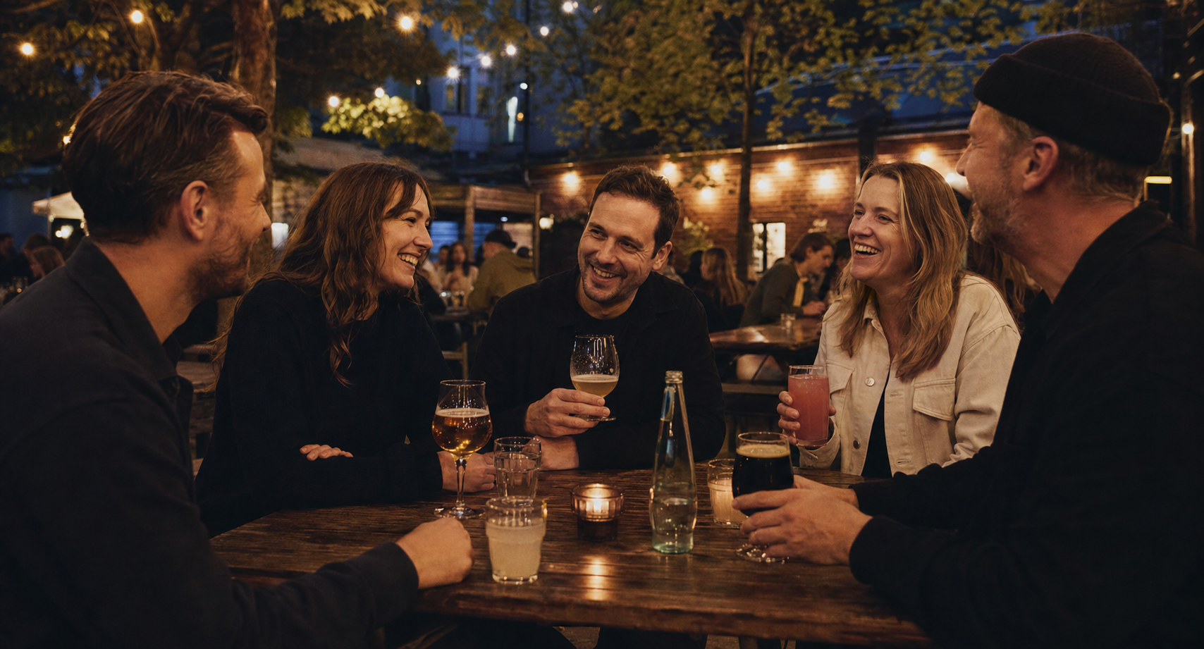 Friends connecting over drinks in a warm Berlin beer garden